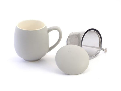 Grey porcelain mug with a metal tea infuser and matching lid on a white background
