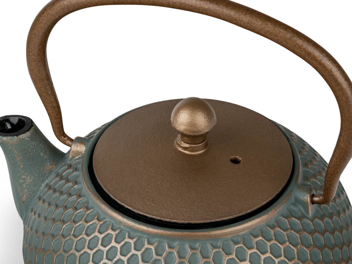 Teapot with textured surface and dark gold lid and handle on a white background