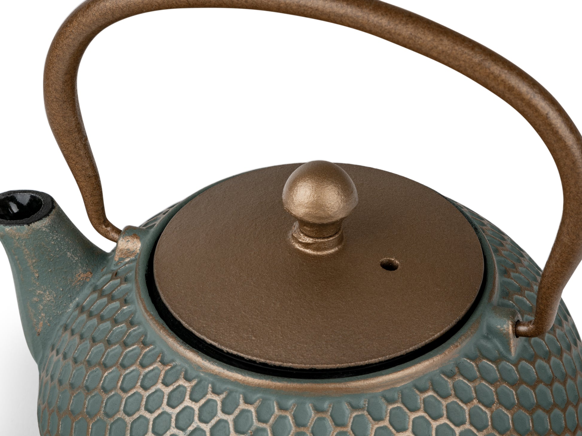 Teapot with textured surface and dark gold lid and handle on a white background