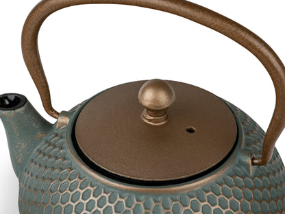 Teapot with textured surface and dark gold lid and handle on a white background