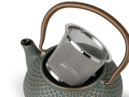 Teapot with a metal filter on a white background