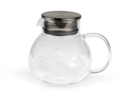 Clear glass round teapot with metal lid and infuser on a white background