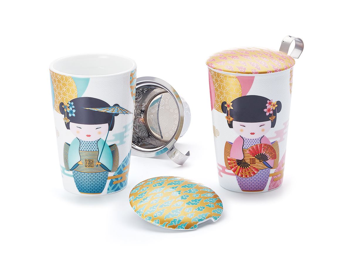 Two tea mugs with colorful designs and metal infusers on a white background 