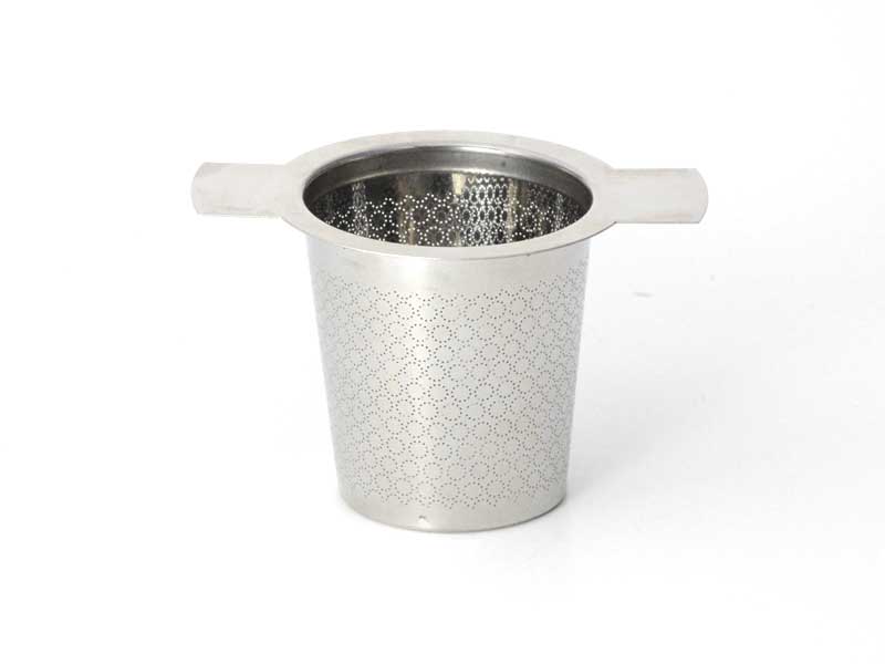 Metallic tea strainer with finely patterned holes and two handles sitting on a white background