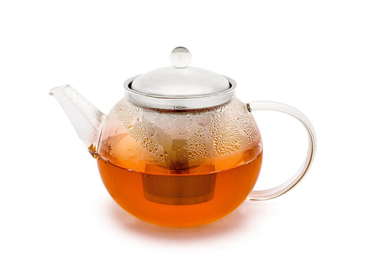 1.2 litre curved clear glass teapot with a stainless steel infuser filled with hot tea on a white background