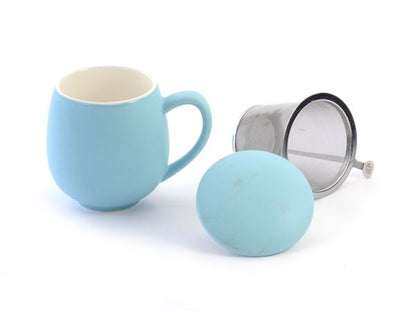 Light blue porcelain mug with a matching lid and metal tea filter on a white background