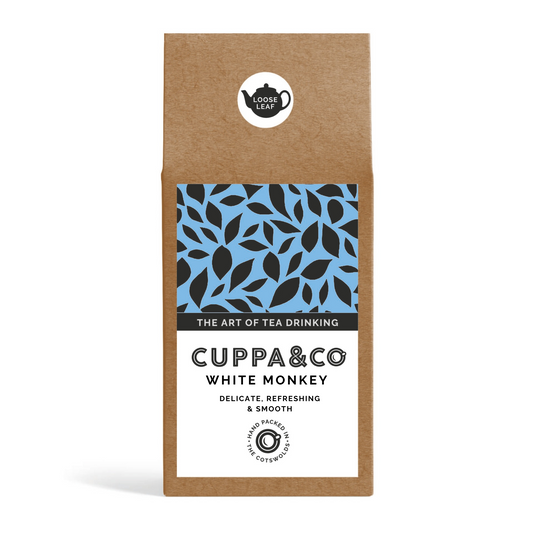 Packaging of Cuppa&Co White Monkey tea, featuring a brown Kraft box with blue and black leaf pattern and product information on the label.