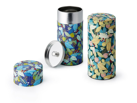Colorful cylindrical tea canister with a lid on a white background