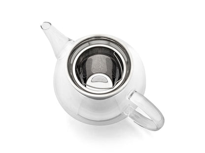Curved clear glass teapot with metal infuser on a white background