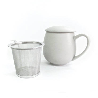 Grey porcelain mug with matching lid and metal tea infuser on a white background