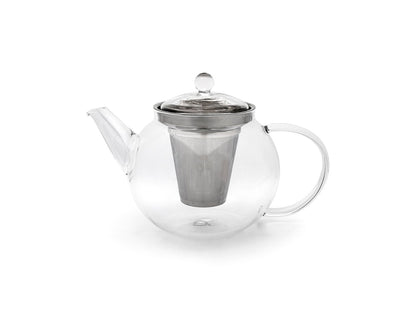 Curved clear glass teapot with metal infuser on a white background