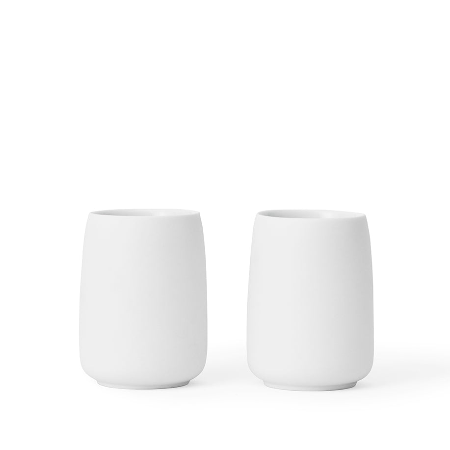 Two white matt porcelain cups on a white background